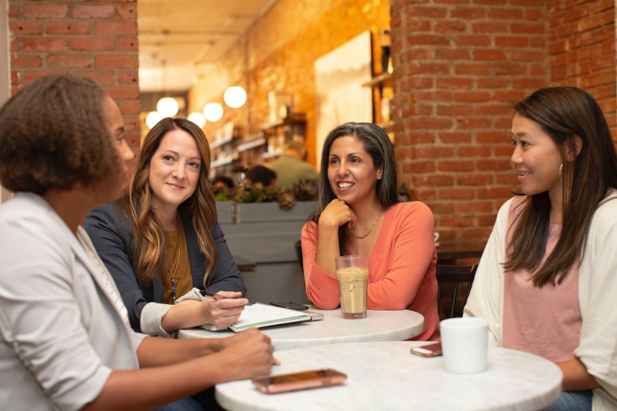 women Four women working in a business meeting in a cafe coffee shop