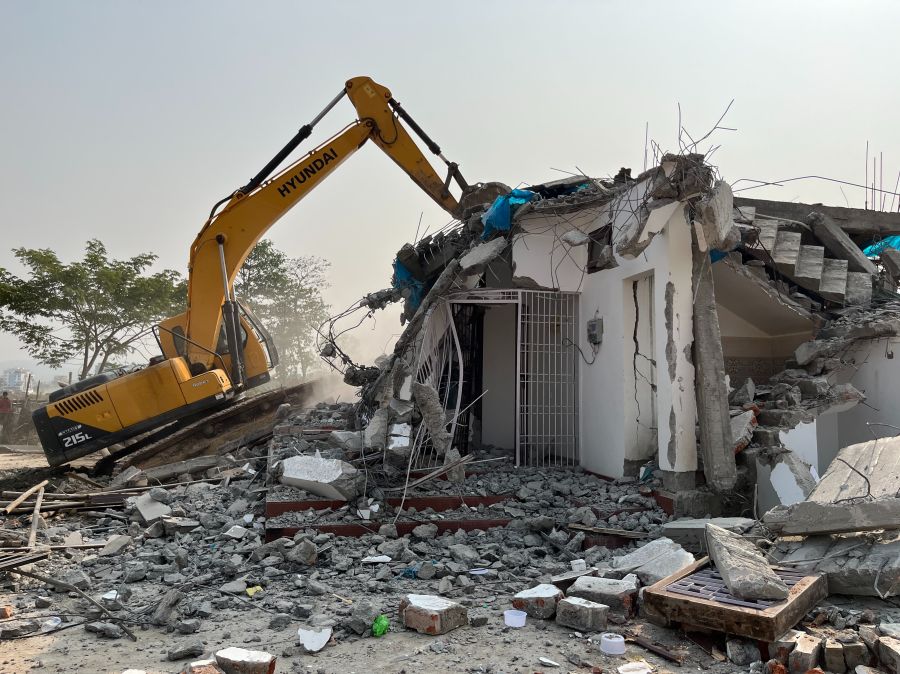 Eviction Expulsion House demolition using bulldozer during an anti encroachment eviction drive in Guwahati, Assam, India. india,guwahati,demolition