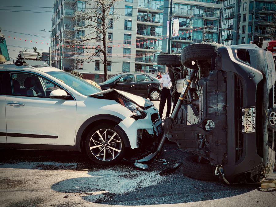 accident Rollover car crash automobile traffic accident broadside collision causing rollover with first responder firemen stabilization brace deployed.
