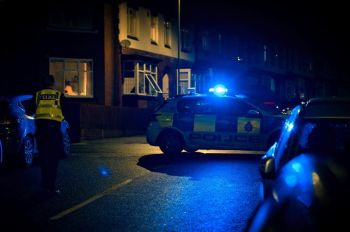 burglary crime The policeman is investigating a crime in the city at night