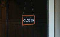 club closure Closed sign hanging on a window 