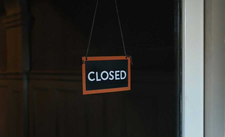 club closure Closed sign hanging on a window 
