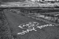 Controversy Controversial Mask or Stay Home spray painted on walkway, black and white photo. grey,portland,or