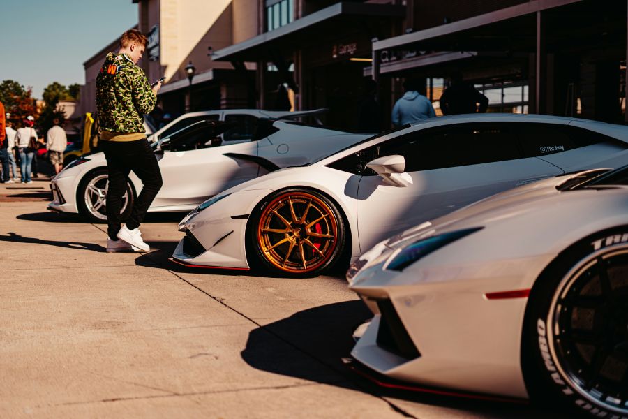 Car meet nice lineup of 2 Lamborghini's and a Corvette - with a hypebeast in the background
 