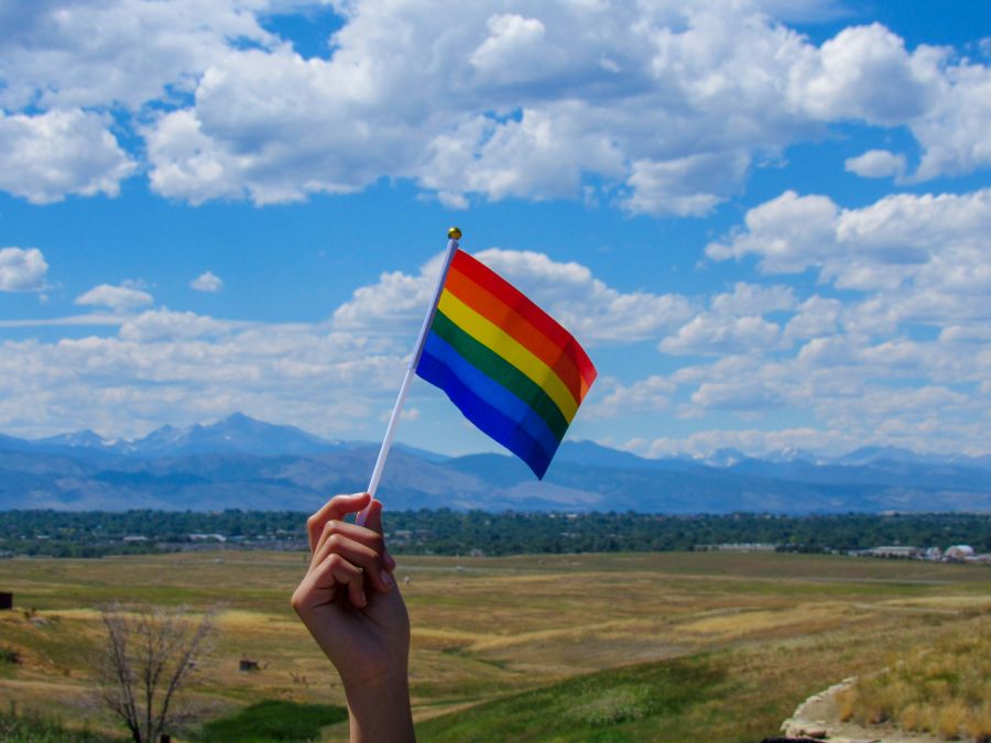 Inclusivity Pride flag against the Colorado mountains and clear sky. colorado,flag,outdoors