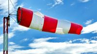 Weather Forecast A blown windsock at small Notodden airport in Norway. Blue sky with white clouds enriches the picture. Looks a little bit that the wind blowing through the sock creates a cloud. merdevegen,norwegen,notodden