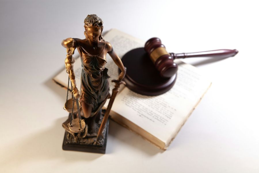 Courtroom Justice Statue of justice, gavel and books on white background. 