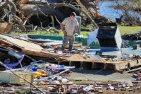 Collapsed buildings Man looking at loss of house after tornado cambridge shores,usa,current events