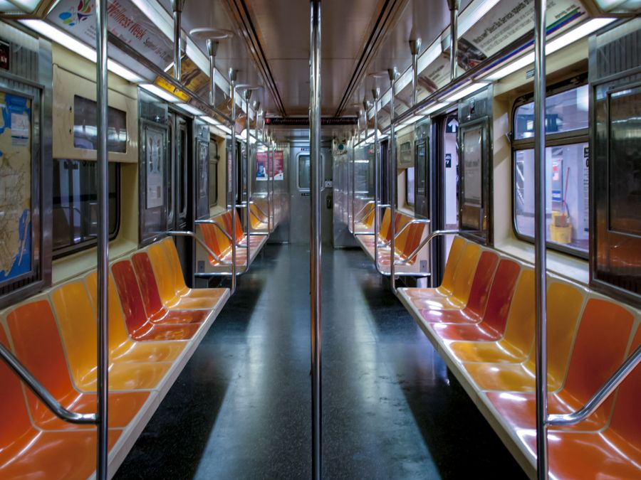 Metro train Empty orange, red, and yellow seats on a subway train in New York city. new york,pandemic,covid19