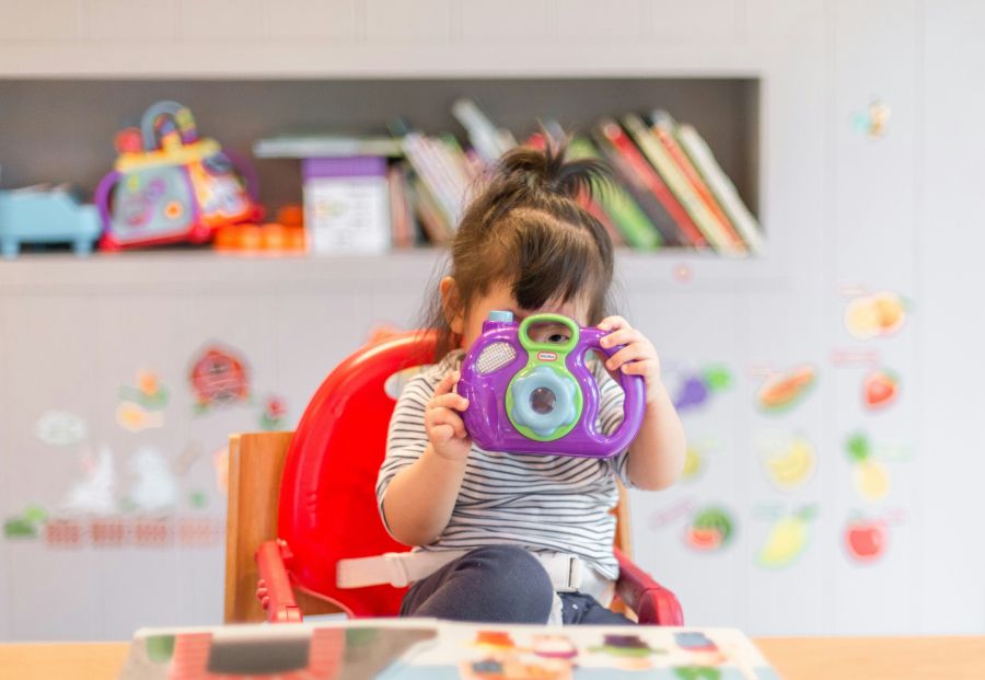 Childcare nursery  young girl,cameraperson,female photographer