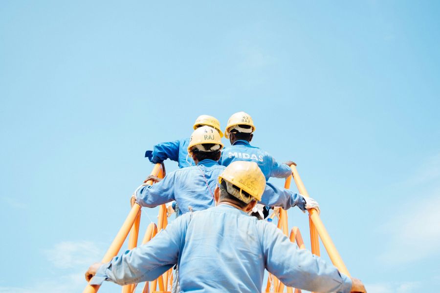 Compensation workers in a Singaporean shipyard disembark a gas vessel during a planned fire drill. worker,people,construction