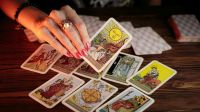 Forecast Tarot card of Waite in hand on dark backgroud
Say 