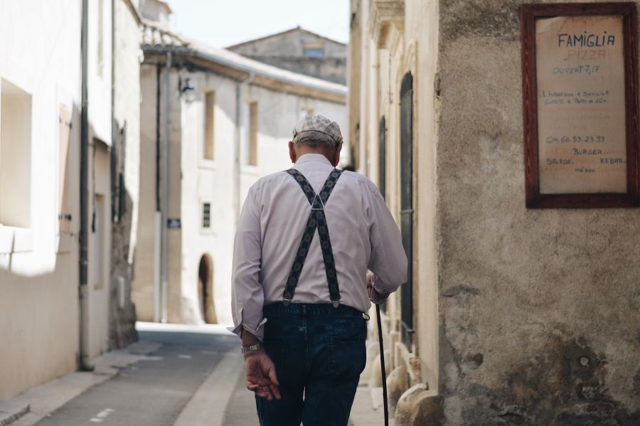 Camargue woman The back of the old man walking in the street south of france,pension,french village