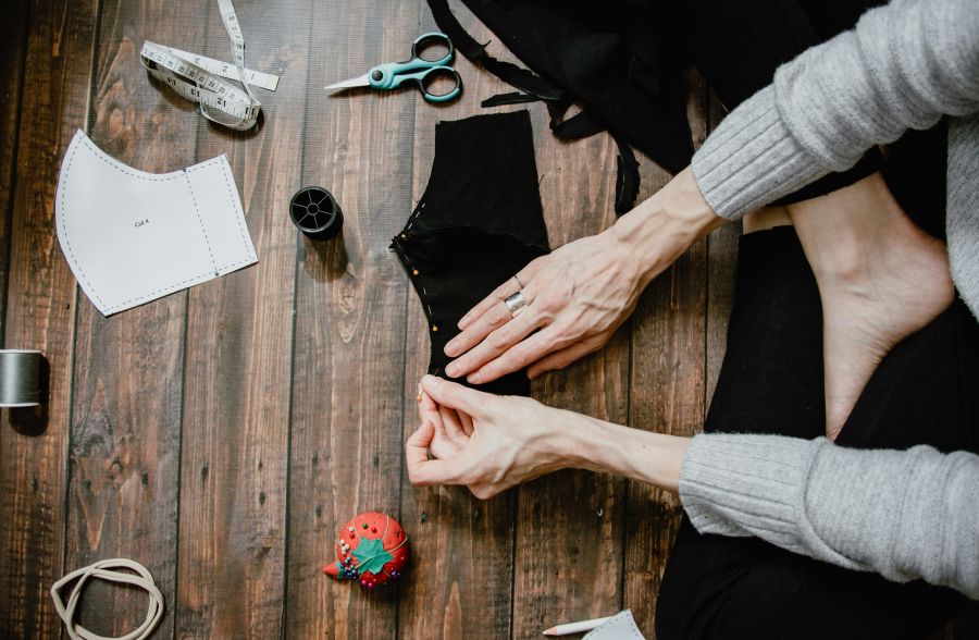 handmade Hand sewing a face mask with pins 