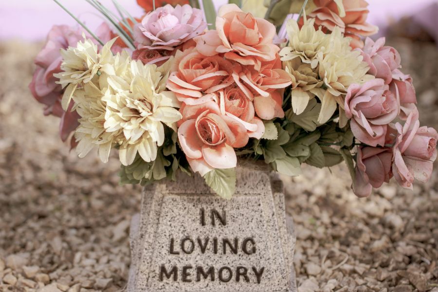 Tragedy grieving Faded flowers on a grave memory,death,dying