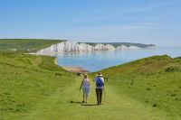 Retirement An old couple walking towards the Seven Sisters 