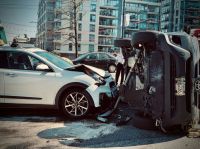 Accident Rollover car crash automobile traffic accident broadside collision causing rollover with first responder firemen stabilization brace deployed. 