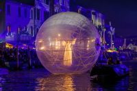 Entertainment Cultural A performer radiates ethereal beauty inside a giant lit orb during the Venice Carnival's opening ceremony at night, feb 2019 venice,italy,metropolitan city of venice
