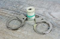 Trial Crime Handcuffs and usa dollar banknotes on wooden background. More of my photos and videos Adobe Stock:http://bit.ly/3RqlciK More of my photos and videos Shutterstock: https://www.shutterstock.com/g/ALEKSANDRBERDYUGIN My email: bermix999@gmail.com 