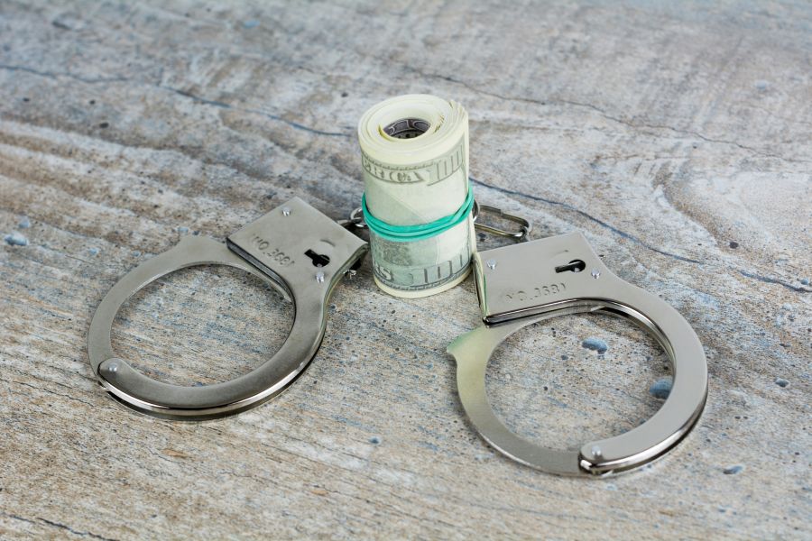 Trial Crime Handcuffs and usa dollar banknotes on wooden background. More of my photos and videos Adobe Stock:http://bit.ly/3RqlciK More of my photos and videos Shutterstock: https://www.shutterstock.com/g/ALEKSANDRBERDYUGIN My email: bermix999@gmail.com 