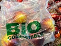 Composting A bio compostable bag for loose fruit and vegetables is offered by a supermarket in Spain.  plastic wrap,food,candy