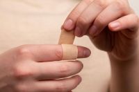 injury The man seals the wound with adhesive plaster. The medicine. Injury. Wound. Infection. First aid. Pain 