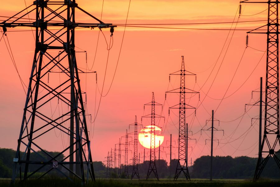 Energy transition power line NP background of the sunset, a lot of supports for wires 