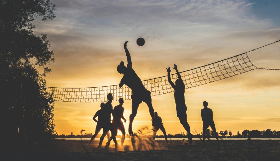 Volleyball A group of friends play beach volleyball while the sun is setting. Taken on a warm summer evening at the Loosdrechtse Plassen in the Netherlands. sport,volleyball,sunset