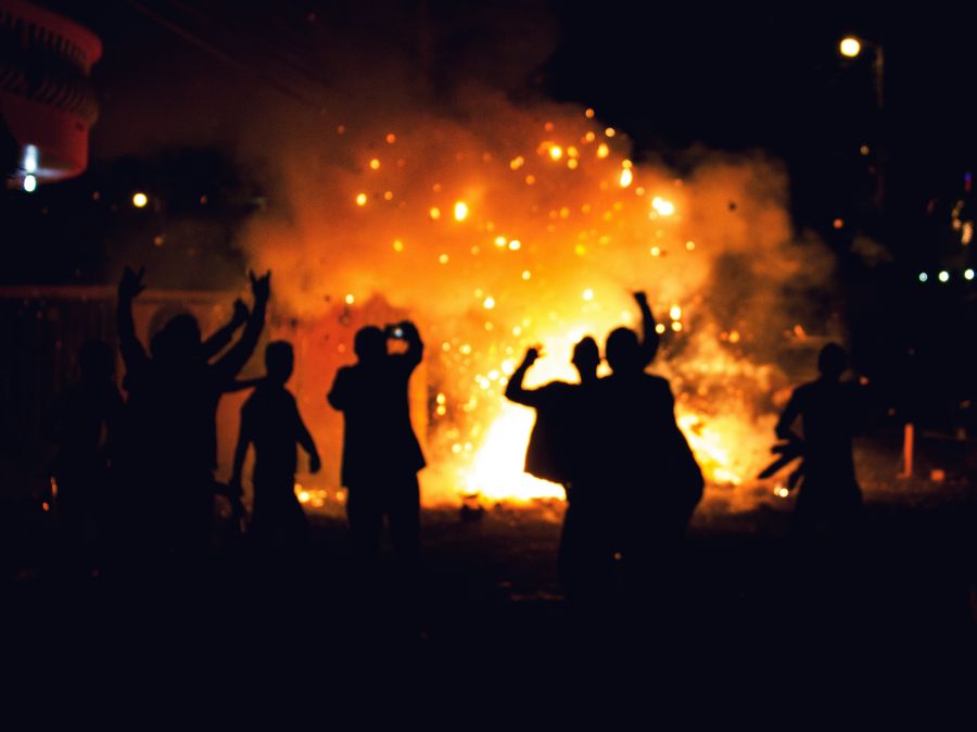 protest violence People gathering near a bonfire at night.  