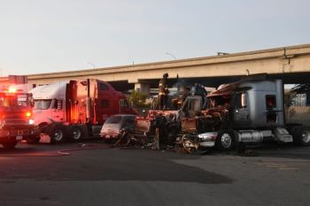 truck fire Oakland firefiters in a truck putting out fire