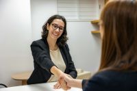 recruitment Young Woman in Business Attire Shaking Hands With Recruiting Manager After Job Interview 