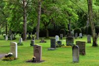 cemetery tomb stones in a park 