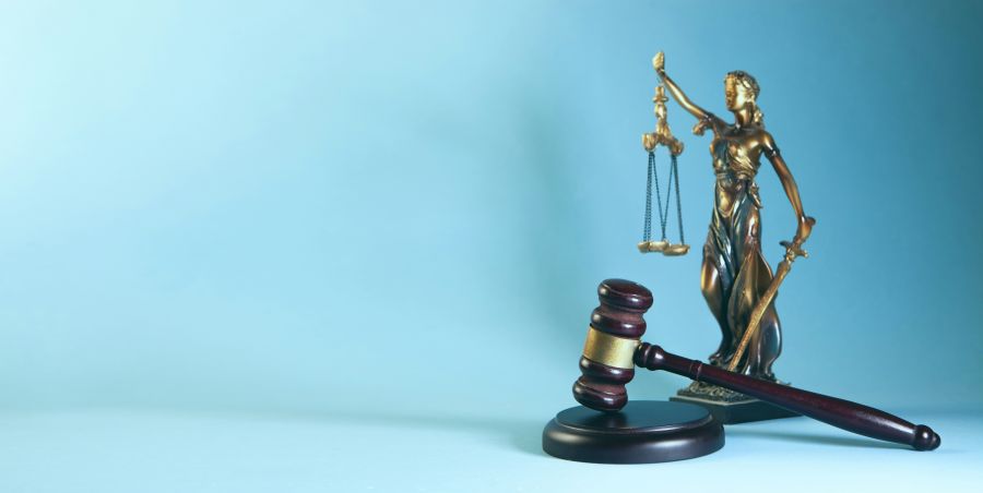 Justice Trial law theme, mallet of the judge and scales of justice on a blue background 