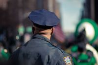 Police officer Policeman watching the St Patrick's parade watchman,cop,cop hat