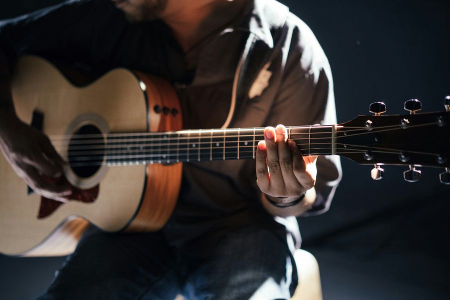 Music Acoustic guitar player in pale light music,guitar,person