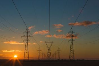 Energy transition Power pylons at sunset