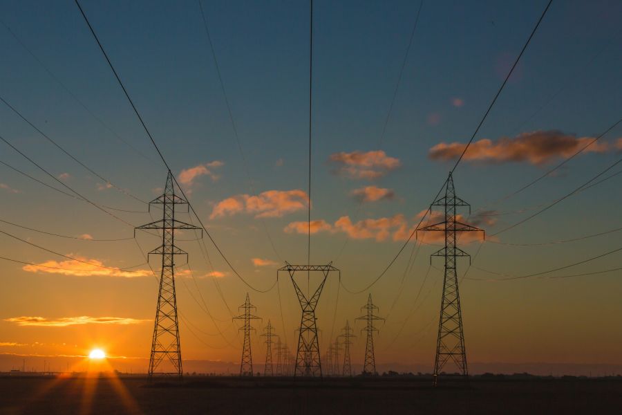 Energy transition Power pylons at sunset 