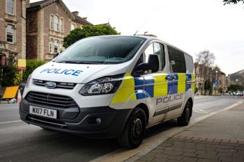 police warning UK Police Van, white stickered Ford Transit van from the Avon and Somerset Police force shot on the streets of Clifton, Bristol
