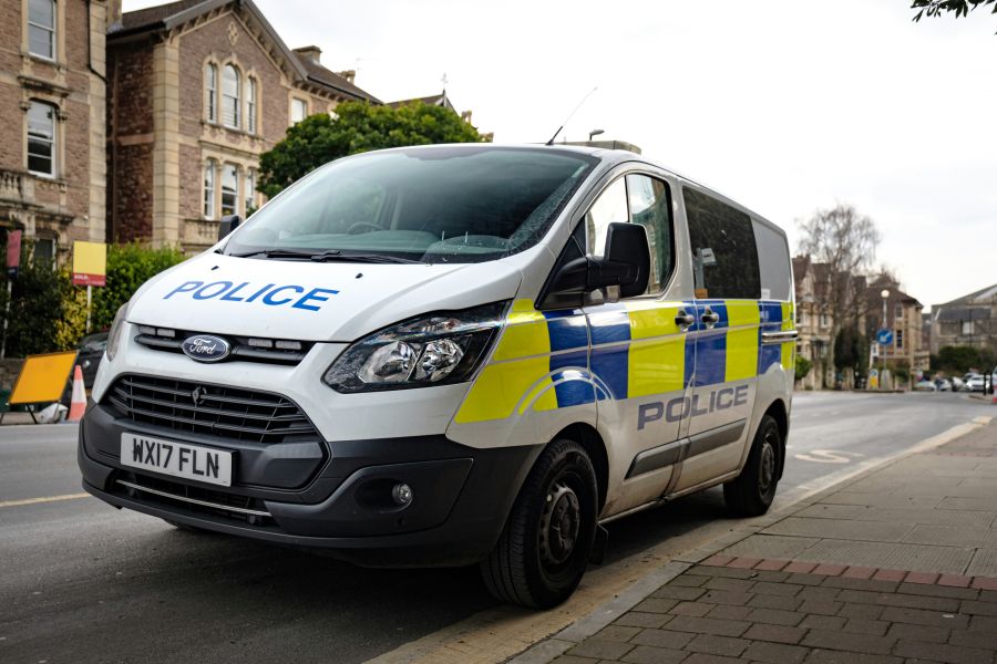 police warning UK Police Van, white stickered Ford Transit van from the Avon and Somerset Police force shot on the streets of Clifton, Bristol 
