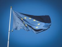 Community Solidarity European Union flag flying in front of bright blue sky flag,photography,photograph