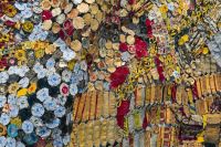 recycling upcycling Colorful Mosaic Made of Recycled Metal Bottle Caps and Packaging - A close-up view of a large mosaic made from recycled materials, primarily bottle caps and packaging. The mosaic features a vibrant mix of colors, textures, and shapes, highlighting the creativity and artistry of reusing discarded items. 