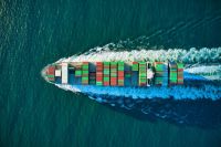 cargo ship Colorful cargo ship headed out to see aerial