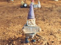 Suspects hate A small garden gnome holding a sign that says 