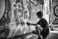 Street artist A graffiti artist in Leake Street Tunnel under the Waterloo station, London grey,london,united kingdom
