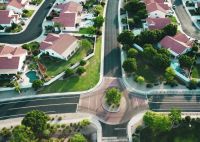 Real estate Drone shot looking forward in a suburb. 