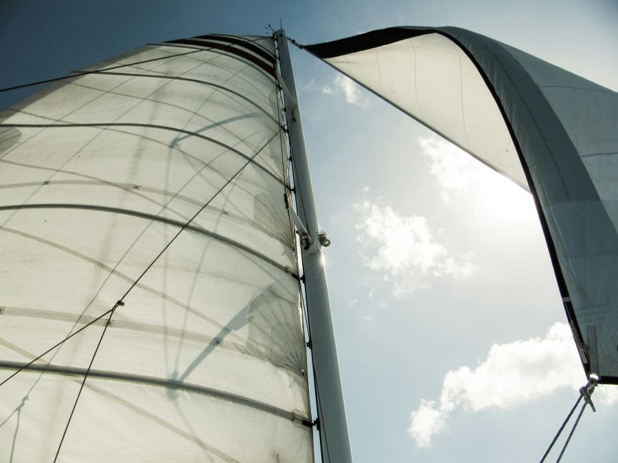 sailboat solar Looking up at white canvas sailboat sails in the wind 