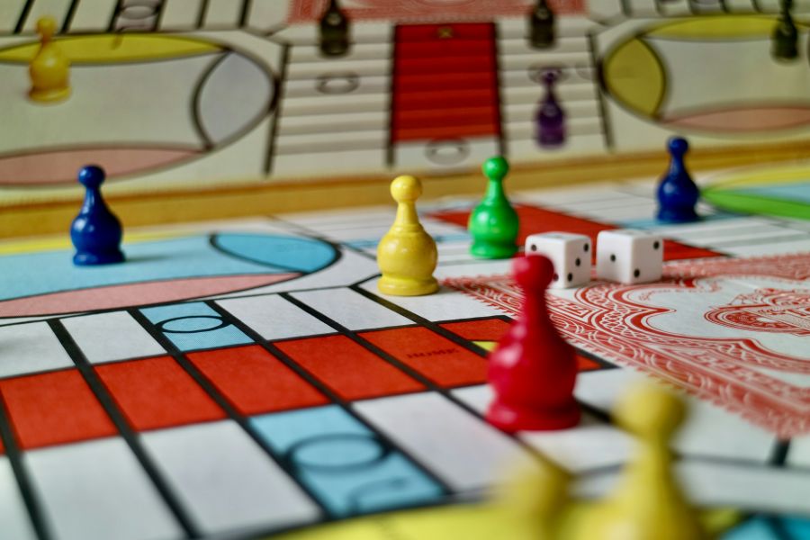 Board games A game of parcheesi in progress featuring a vintage 1980s game set. vintage,india,board game