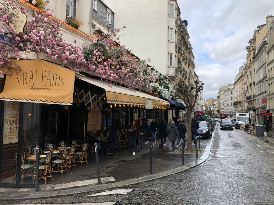 Paris street Paris streetview Montmartre cafe with pink flowers 