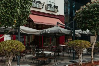Emirati cafe Outdoor seating area of a L'ETO café with umbrellas and greenery in Dubai City Walk district