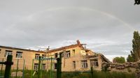 School damage The photograph depicts the remnants of a once vibrant school now reduced to ruins by the ravages of war. Impressively woven from the debris, it symbolizes loss and resilience. In this poignant scene of destruction, a rainbow stretches over the desolation, as if attempting to pierce through the clouds of adversity. It becomes an invisible bridge between the past and the future, a symbol of hope for reconstruction and a new beginning. 